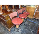 Three vintage wooden and metal bar stools