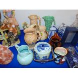 Nine assorted jugs and a blue and white biscuit barrell