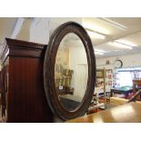 An Oval Mahogany wall mirror