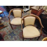 A pair of elbow chairs