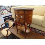 An Oval inlaid three drawer chest,