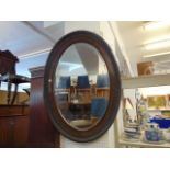 An Oval Mahogany wall mirror