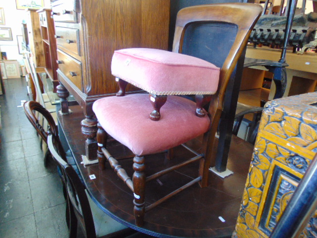 A Pink upholstered chair and foot stool
