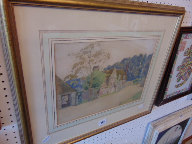 A framed watercolour, village cottage scene, signed,