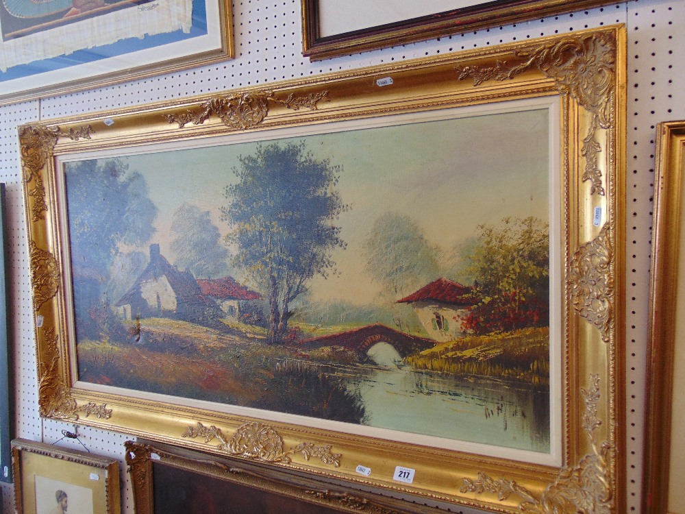 A gilt framed landscape oil signed