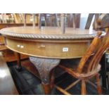 An Oval mahogany extending table on ball and claw feet