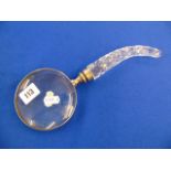 A cut glass magnifying glass