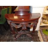 A carved Mahogany console table