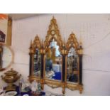 A 20th century French Gothic style carved and gilded wooded mirror