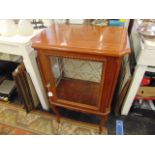 An Italian mahogany cabinet with glass front