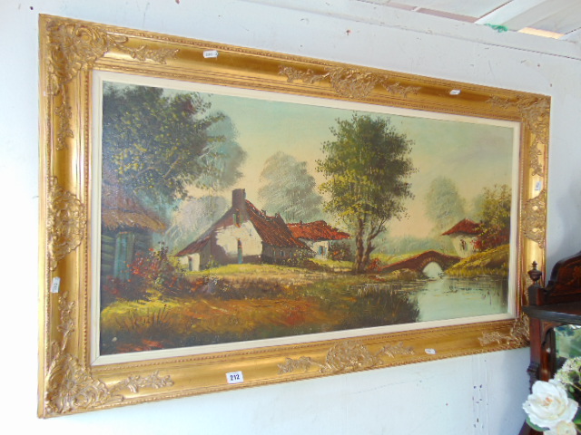 A gilt framed landscape oil signed