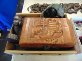 A carved box and two African wall plaques