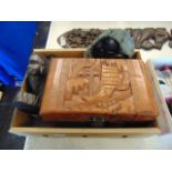 A carved box and two African wall plaques