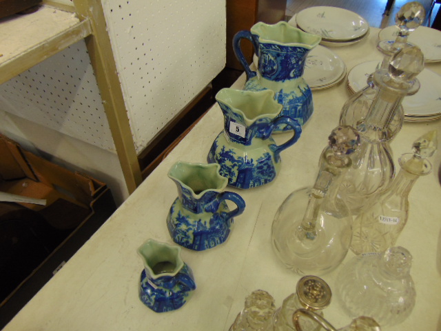 A set of four graduated jugs,