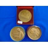 Three assorted bronze medals; Artdeco Nude lady making tapestry by P.