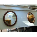 Two oval framed mirrors