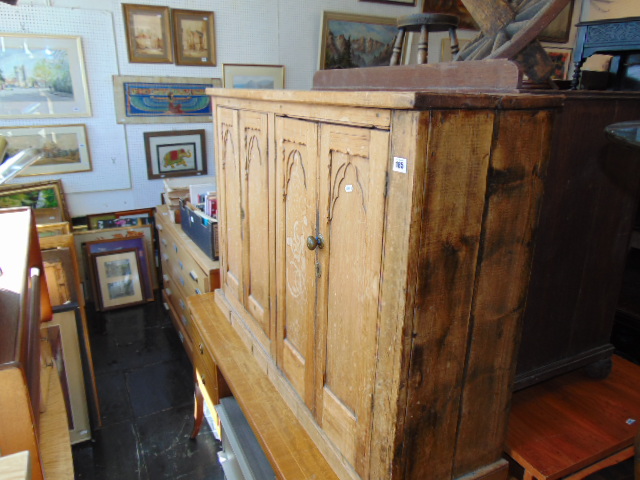 A Pine Gothic style cabinet with one interior drawer, a.