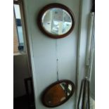 Two oval framed mirrors