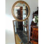 A gilt/ circular wall mirror,