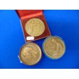 Three assorted bronze medals; Artdeco Nude lady making tapestry by P.