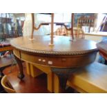 An Oval mahogany extending table on ball and claw feet