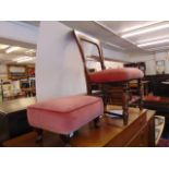 A Pink upholstered chair and foot stool