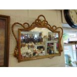 An ornate gilt framed wall mirror