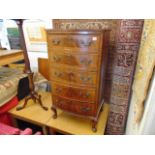 A Walnut five drawer bow fronted chest