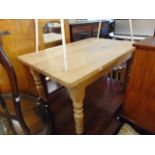 A pine kitchen table, 54 x 35 inches approx.