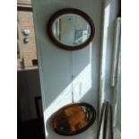 Two oval framed mirrors