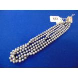 Three Grey pearl necklaces,