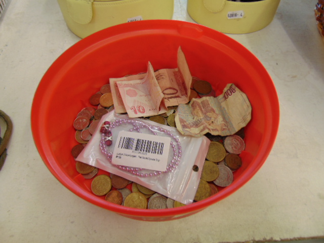 A collection of mixed coins and banknotes