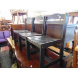 A set of four black chairs