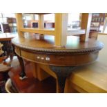 An Oval mahogany extending table on ball and claw feet