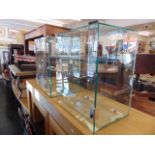 Two glass display cabinets with keys,