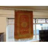 A Persian Silk rug, 100cms x 200cms approx.