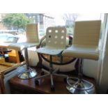 Three white and chrome bar stools