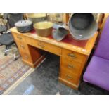 An Oak pedestal desk with leather top