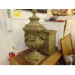 A stone garden urn on base