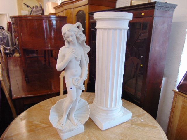 A lady figure on pedestal