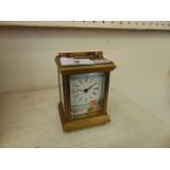 A brass and enamel miniature carriage clock with key
