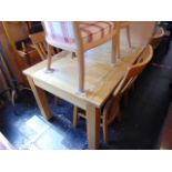 A light Oak dining table and four slat back chairs, table 52 x 36 inches approx.