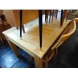 A light Oak dining table and four slat back chairs, table 52 x 36 inches approx.