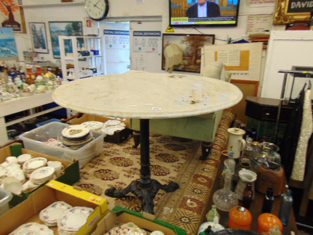 A marble top and iron base pub table