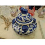 A blue and white oriental lidded jar/ urn