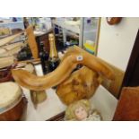 A large designer wooden Eel on a stand,