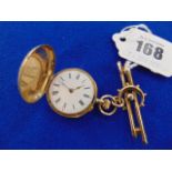 An enamelled 14ct pocket watch and a 9ct Brooch, Dog clip,