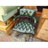 A green leather button back office chair