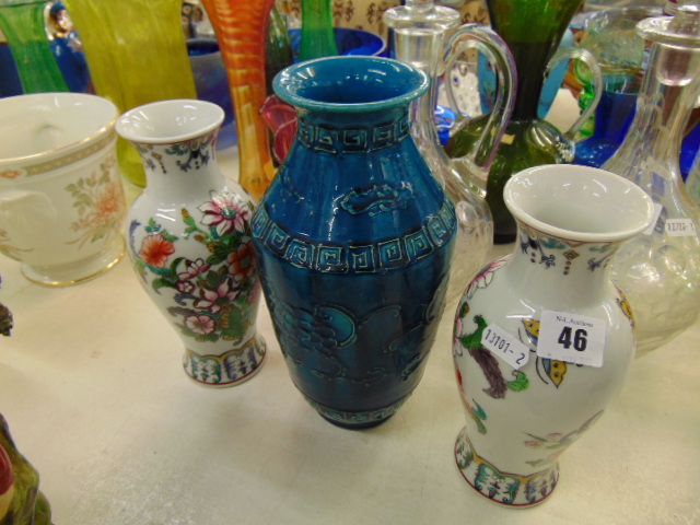 A pair of Oriental vases and another vase