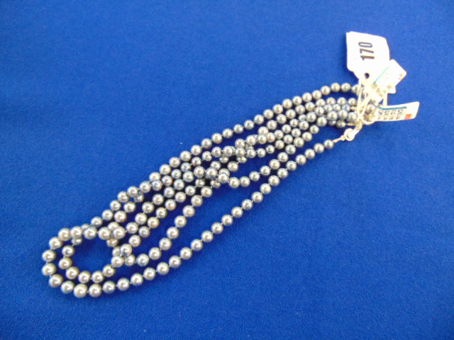 Three Grey pearl necklaces,